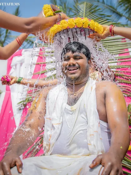 The groom enjoying the refreshing and symbolic bathing ritual. We capture the joy and significance of these traditions with a focus on candid, happy expressions.
