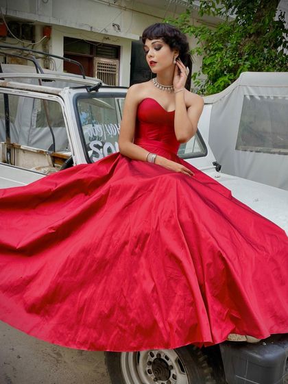 A vintage-inspired photoshoot with our custom red ball gown. The sweetheart neckline and full taffeta skirt create a timeless, romantic look.
