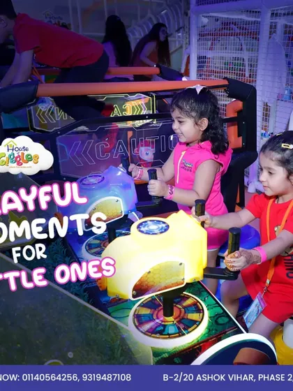 Playful moments for little ones! These two sisters are enjoying our dual-player arcade rides, racing side-by-side in a world of colorful lights and sounds.