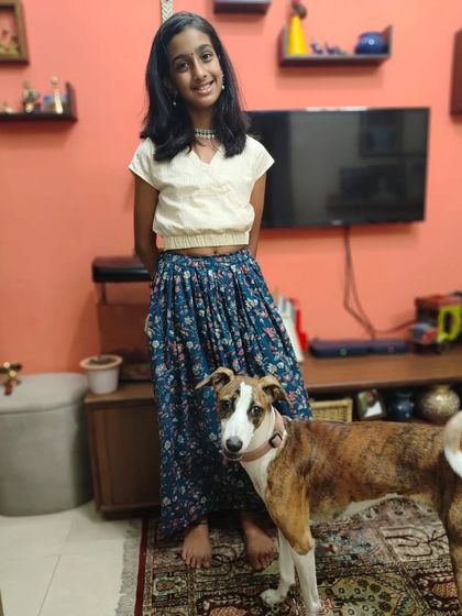 It’s always a joy to see my clothes being loved, even by furry family members. This young girl looks so comfortable and chic in our floral skirt and cream crop top.