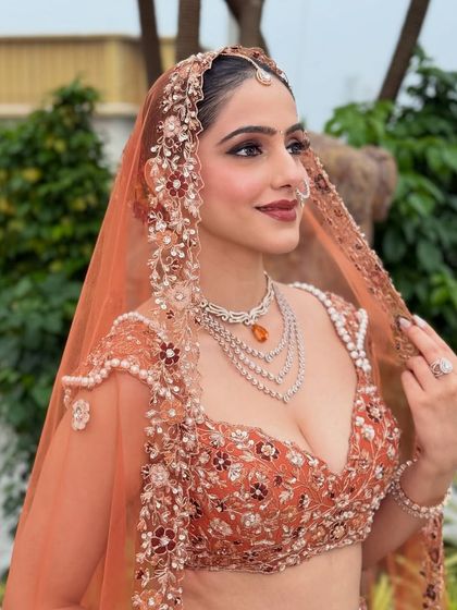 A side profile showcasing the soft, shimmering eye makeup and the elegant draping of the dupatta. The makeup is blended seamlessly to look flawless from every angle.