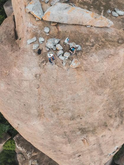 A top down drone shot of climbers relaxing on the summit of Gaali Kallu. The sense of community and shared experience is what makes these climbs special.