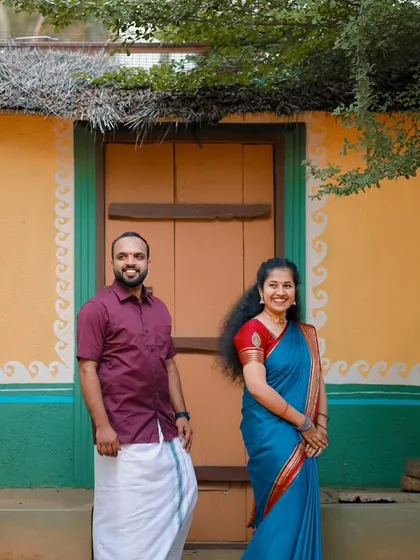 A charming shot in front of a colorful, rustic village house. This setting is perfect for couples who want a traditional and down-to-earth pre-wedding theme.