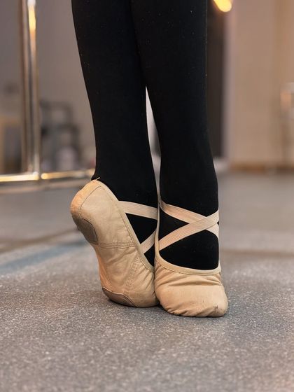 A ballerina's feet tell a story of strength and dedication. These close ups show both soft ballet slippers and hard pointe shoes, representing the different stages of a dancer's journey.