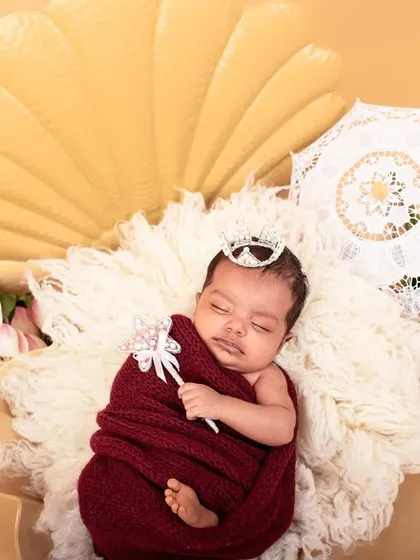 Another view of the 'pearl in a shell' newborn setup. The tiny crown and wand add a touch of royal magic to this creative portrait.