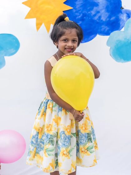 A bright and cheerful floral dress perfect for a sunny day. The simple silhouette is comfortable for play, while the print is full of life and color.