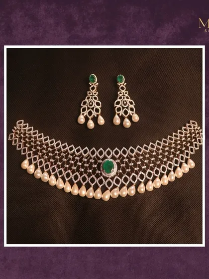 With a touch of emerald and a statement of grace, this diamond lattice necklace is breathtaking. The pearl drops add a soft, classic finish to a truly regal piece.