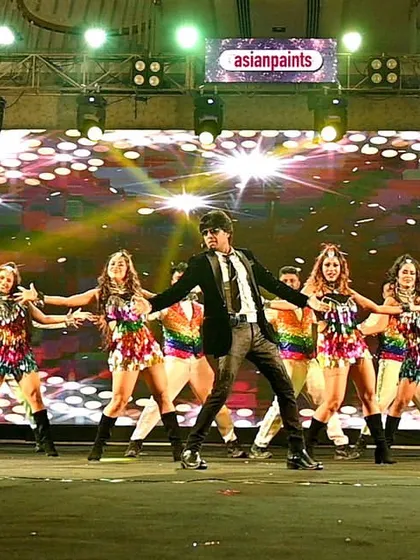 The full team spread out on the ramp stage for Asian Paints. The scale of the production is evident in this wide shot.