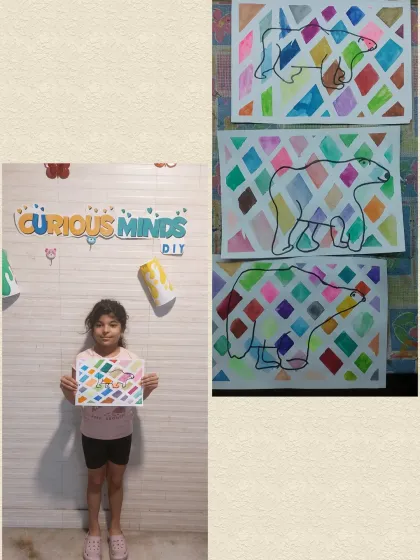 A student proudly displays her colorful polar bear artwork. This was the creative part of our Arctic Habitat session, where she used her imagination to paint a beautiful scene.