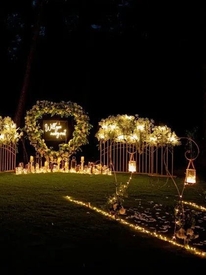 As night falls, the lighting becomes the main feature. This view shows how the combination of lanterns, fairy lights, and candles creates an enchanting glow throughout the outdoor space, making the entire area feel intimate and secluded.