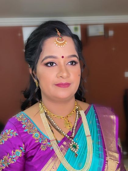 A close-up portrait of Swathi. Her makeup is natural and radiant, letting her own beauty shine through.