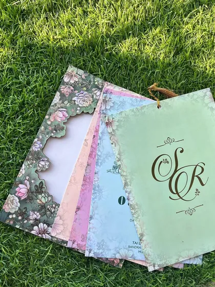 The complete suite of the green floral laser-cut invitation, showing how the theme carries across all the different inserts for various functions.