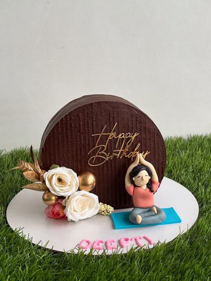 This "cake top forward" design is a modern and elegant trend. We personalized this chocolate cake with a handmade fondant yoga figurine for a yoga lover's birthday.