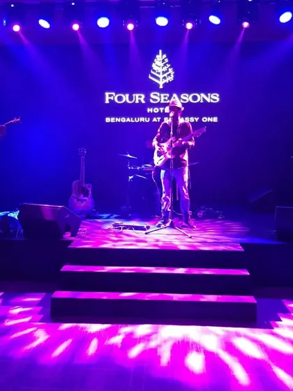 Our trio setup on the beautifully lit stage at the Four Seasons, ready to entertain a corporate gathering.