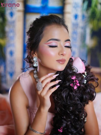 A close-up on the soft pink graphic eyeliner and glossy lips, perfect for a dreamy, fantasy look.