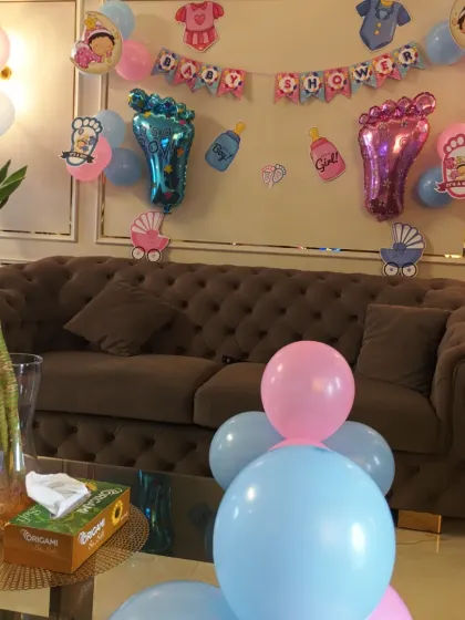 The baby shower decorations set up in the client's living room, showing how we can transform a home space for a special occasion.