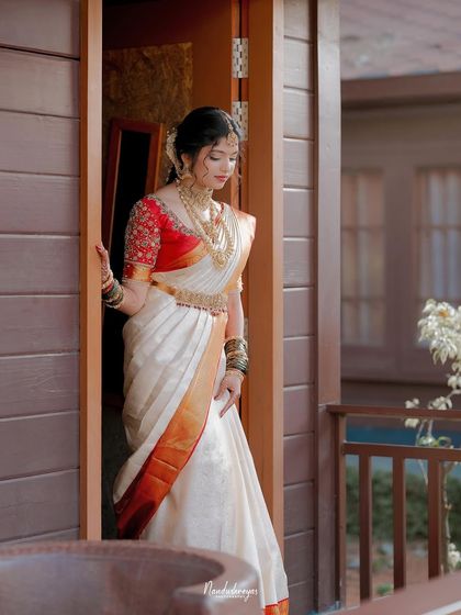 The bride framed in a doorway, a symbolic and beautiful portrait. This shot captures her elegance as she prepares to step into a new chapter of her life.