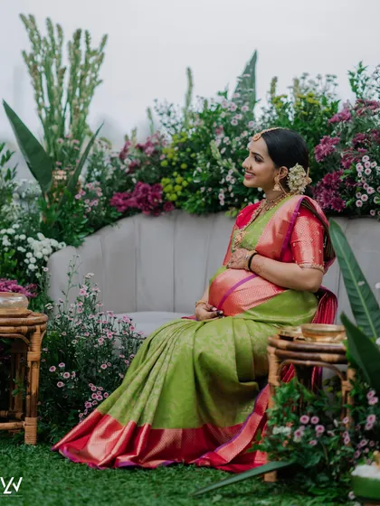 A beautiful shot from a maternity photoshoot. The saree is draped to flow gracefully, creating a dreamy and ethereal picture.