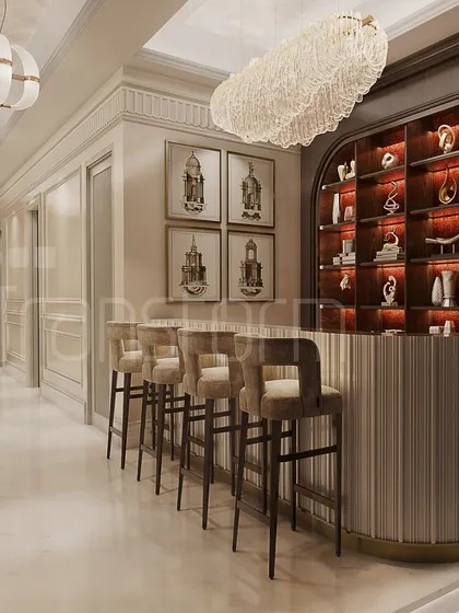A sophisticated bar area that embodies timeless elegance. The design features a fluted bar front, plush velvet stools, and a beautifully curated, backlit display shelf, creating a legacy of refined taste.