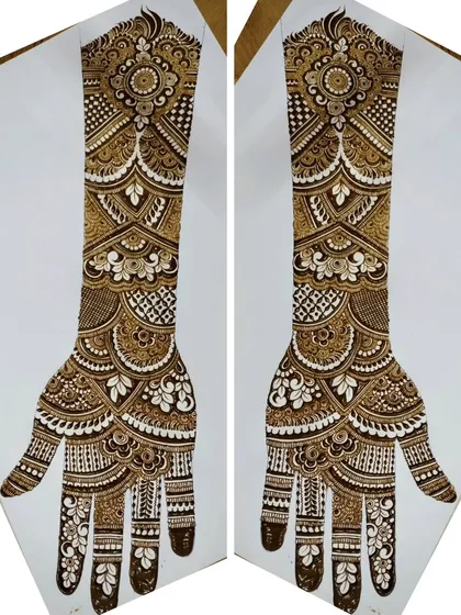 This mirrored image shows a full-arm bridal design, packed with intricate details from the elbow to the fingertips.