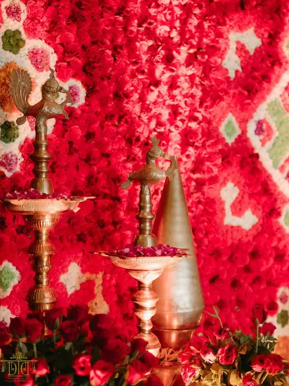 A close-up of the decor details from the Marathi wedding. Traditional brass diyas and a backdrop of vibrant red carnations highlight our commitment to weaving cultural symbols into the aesthetic, making the celebration feel both beautiful and meaningful.