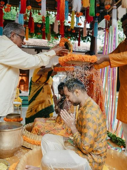 The groom receives blessings from his elders during the Haldi ritual.