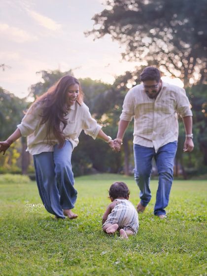A baby's first explorations are a milestone worth remembering. Here, parents watch on with love and encouragement as their little one crawls ahead, a beautiful story of support and independence unfolding.