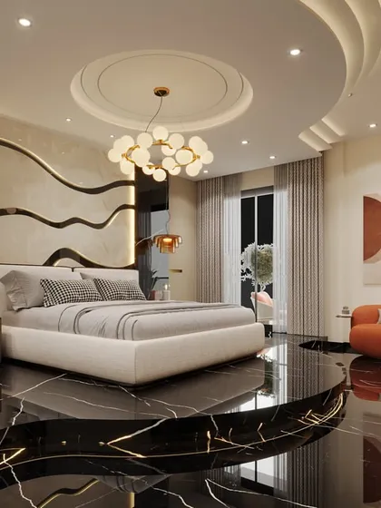 This master bedroom is a sanctuary of modern luxury, designed around a raised platform bed on a polished black marble floor. The space features a custom-designed, multi-layered false ceiling and a contemporary chandelier, creating a sophisticated and serene atmosphere.
