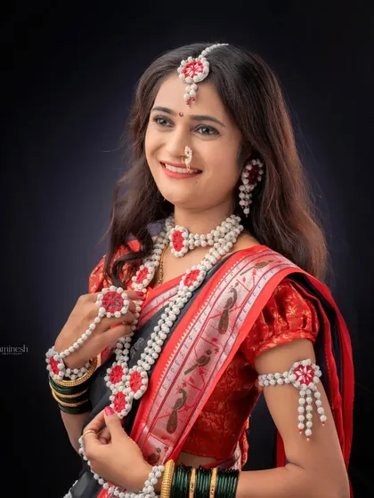 A classic pose showing off the beautiful, handcrafted sugar jewelry worn during Makar Sankranti. I ensure every detail of your festive look is captured.