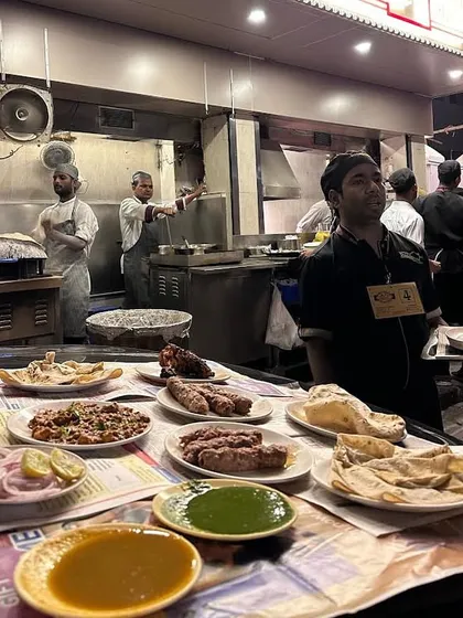 A full spread of our food laid out on a car bonnet, ready to be shared. From seekh kebabs to rich curries and fresh rotis, this is how Mumbai enjoys its nights.