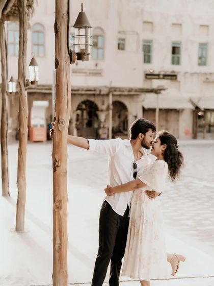 A romantic moment as the couple explores the charming streets of Old Dubai.