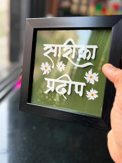 This mini tabletop nameplate is perfect for a couple's desk or a small corner in the home. The green background with white lettering and floral accents creates a fresh and lovely look.