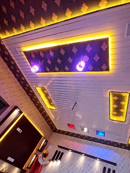 This is a truly unique and grand ceiling I worked on, likely for a prayer room or a special hall. The combination of patterned wallpaper, wood-finish panels, and multiple light sources is breathtaking.