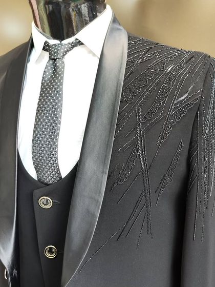 A collection of our designer suits, showcasing a variety of colors, fabrics, and custom details like embroidery, unique lapels, and accessories. Each piece is crafted to make a lasting impression.