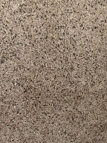 The texture of the original terrazzo flooring, a durable and beautiful material that we aim to repair rather than replace.