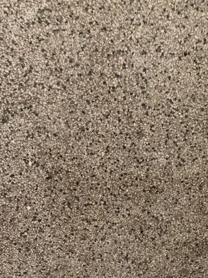 The texture of the original terrazzo flooring, a durable and beautiful material that we aim to repair rather than replace.