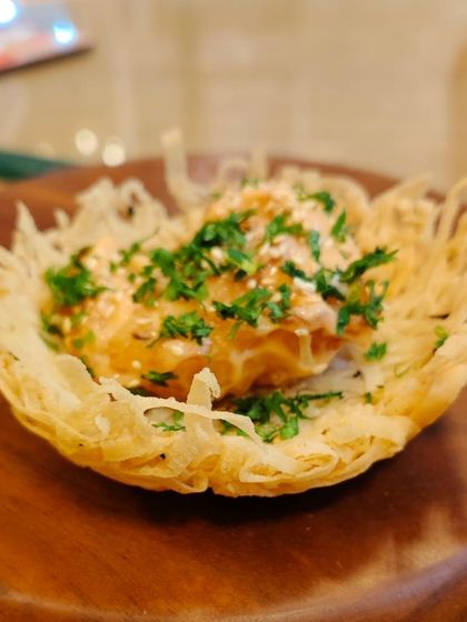 A creative appetizer served in a crispy, edible basket. The filling is a savory mixture that provides a burst of flavor, showcasing our ability to create unique and delicious bites.