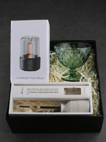 A premium tech and decor hamper, this box includes a candlelight-style diffuser, a porcelain reed diffuser, and a green glass dessert bowl. It's a sophisticated gift for senior clients.