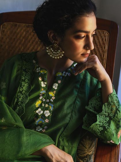 A detailed shot of the intricate embroidery on a green Baavli kurta, a testament to the brand's craftsmanship.