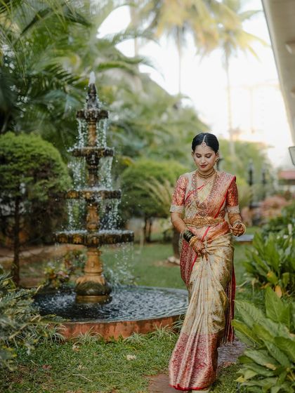 My beautiful client-turned-family, Chethana, looks timeless in this white and pink Kanchipuram saree. I designed a heavily handcrafted bridal blouse with intricate zardozi work to complement the saree's elegance for her special day.