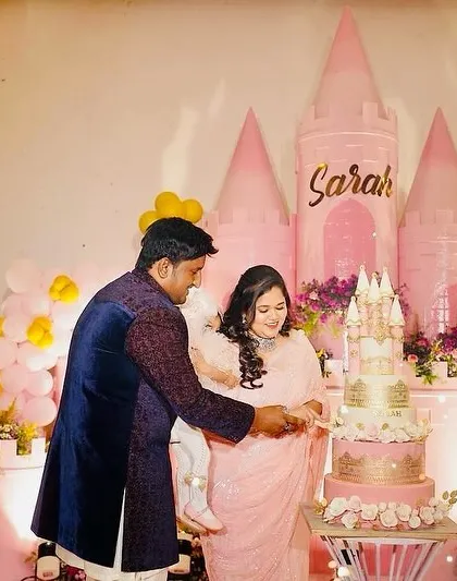 The cake-cutting ceremony at Sarah's party, with the family gathered around the beautiful castle cake.