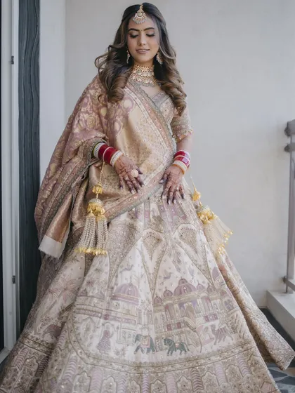 The full bridal look is breathtaking. The soft, open hairstyle balances the grandeur of the lehenga, creating a look that is both regal and modern.