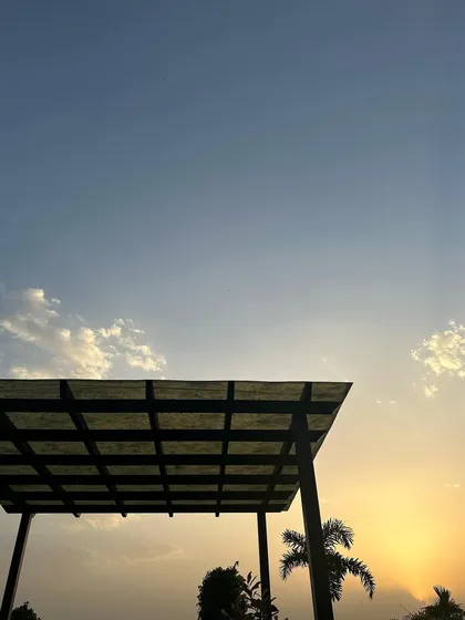 The silhouette of our pergola against a golden sunset. The open sky and clean lines of the space make it a beautiful canvas for any event.