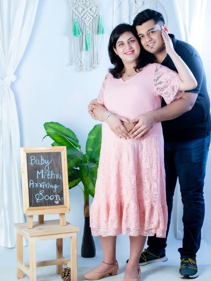 Announcing the arrival of their little one with a personalized chalkboard sign. This is a wonderful way to add a custom touch to your couple's maternity photos.