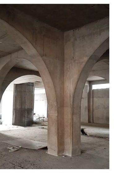 The corner of a concrete arch at Sanskriti Vihara. The raw, powerful geometry of the structure is evident even during the construction phase, hinting at the monumental space to come.