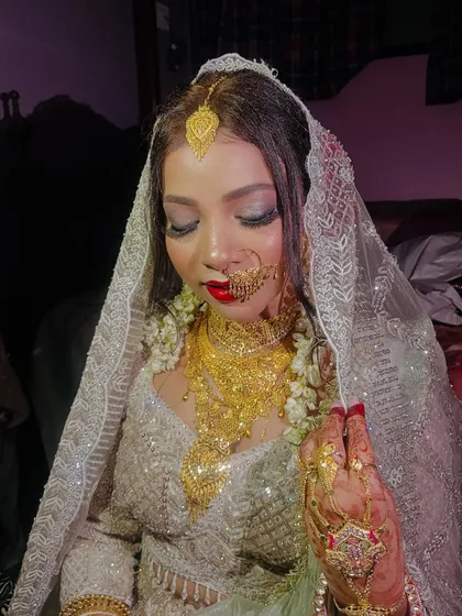 A beautiful close-up of the bride, her eyes closed to show off the stunning silver eyeshadow.