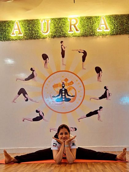 A moment of joy and flexibility in front of our studio's Surya Namaskar mural. Finding balance is about both effort and ease.