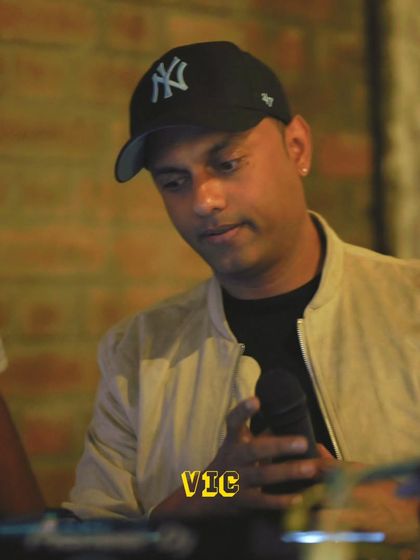 On the mic, interacting with the crowd during the Christmas party. Engaging with the audience is key to building a festive atmosphere.