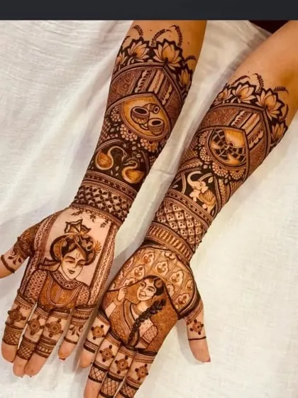 A close up view of portrait work. This design features a bride in her palanquin (doli) on one arm and the groom on the other, capturing a key moment of the wedding journey with fine lines and shading.