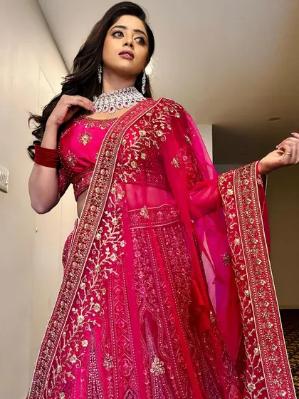 Make a statement at your reception with this gorgeous red lehenga paired with my diamond-finish CZ choker set. It's a perfect example of how I style modern looks for evening events.